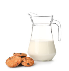 Jug of fresh milk and tasty cookies on white background