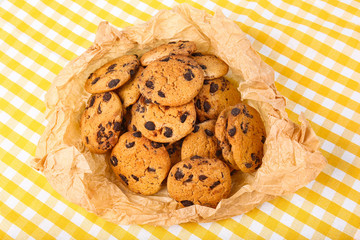 Tasty cookies with chocolate chips on table