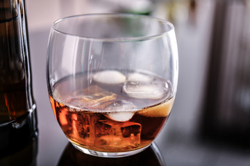Glass of whiskey on table in bar