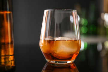 Glass of whiskey on table in bar