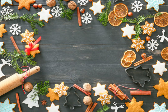 Composition with tasty Christmas cookies and place for text on dark wooden background
