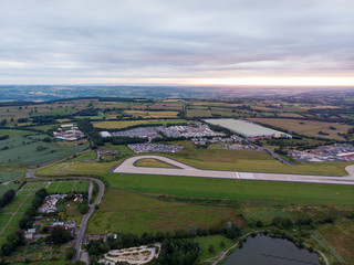 Aerial photo of the famous Leeds and Bradford airport located in the Yeadon area of West Yorkshire in the UK, typical British airport showing the runway and houses and roads around the airport