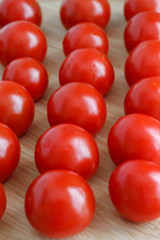 the harvest of ripe tomatoes is on the wooden kitchen table