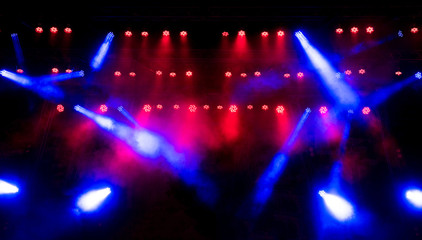 Fototapeta na wymiar Beautiful concert light on an empty stage in the smoke. Disco and laser show.