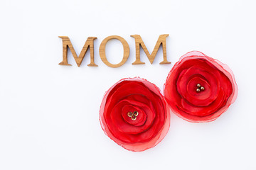 Mother's day card background idea, Mom wooden texture letter with fabric red flower isolate on white background, decoration item mother's day celebration