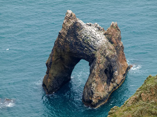 Rock arch of volcanic origin near the sea shore