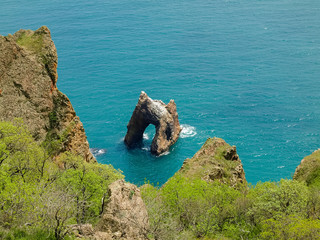 Rock arch of volcanic origin near the sea shore