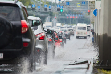 Cars ride through puddles after rain