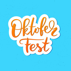 Oktoberfest typography vector design for greeting cards and poster. Beer Festival vector banner. Handwritten lettering Oktoberfest on blue background. Design template celebration. Vector illustration.