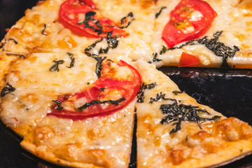 Pizza with tomatoes and cheese. Closeup