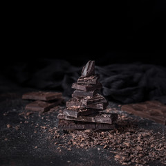 Dark chocolate with chocolate chips on dark background
