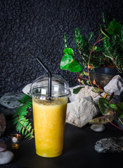 Vegan exotic smoothie with mango sugar free on tropical background