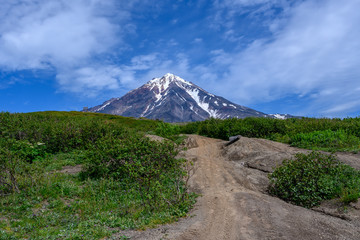 Fototapeta premium Panoramic view of the city Petropavlovsk-Kamchatsky and volcanoes: Koryaksky Volcano, Avacha Volcano, Kozelsky Volcano. Russian Far East, Kamchatka Peninsula.