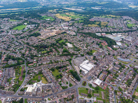 Aerial photo of the town known as Yeadon within the metropolitan borough of the City of Leeds, West Yorkshire, England, showing typical British houses, roads and streets with fields close by.