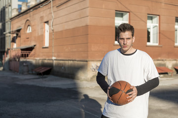 Front view man holding a basketball