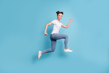 Fototapeta na wymiar Full body photo of jumping lady hurrying shopping wear white casual t-shirt jeans denim isolated blue background