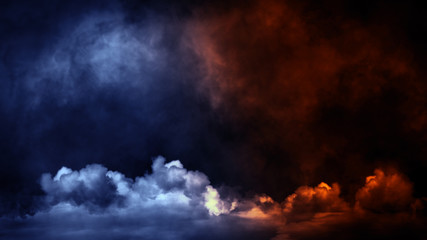 Blue orange gradient toned . Rolling billows of smoke mist clouds from dry ice across the bottom light . Fog on floor isolated background black texture .