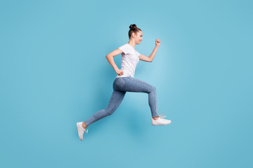 Fototapeta na wymiar Profile photo of excited lady hurrying shopping wear white casual t-shirt jeans denim isolated blue background