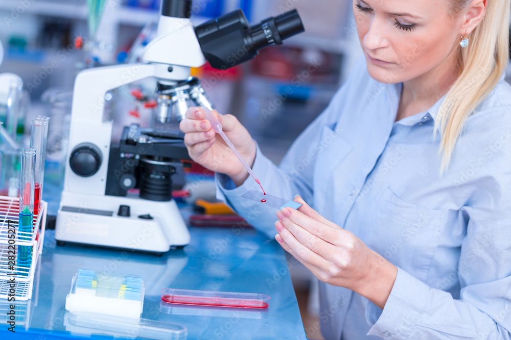 Sticker Laboratory assistant uses a polarizing microscope in a microbiological laboratory