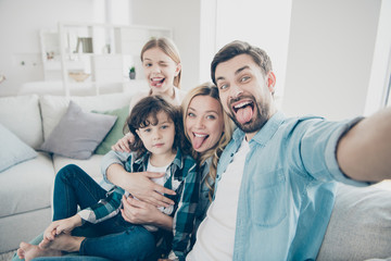 Photo of family two children making selfies weekend great mood sticking tongue out mouth best...