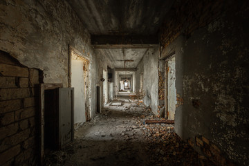 Fototapeta na wymiar Abandoned corridor in damaged building