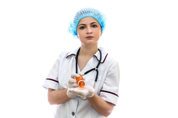Doctor's hands in gloves with bottle and yellow capsules