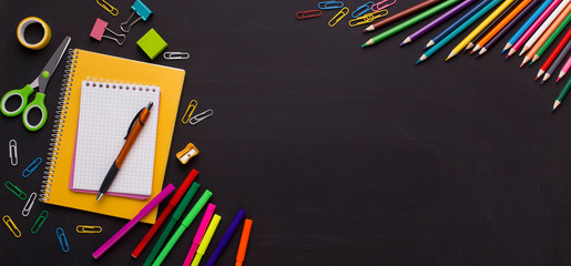 School and office stationery on chalk board background