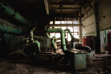 Fototapeta na wymiar Dark industrial interior with machinery inside