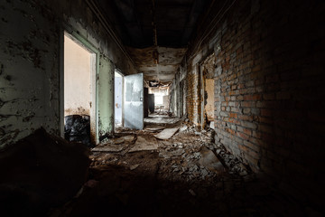 Fototapeta na wymiar Abandoned corridor in damaged building
