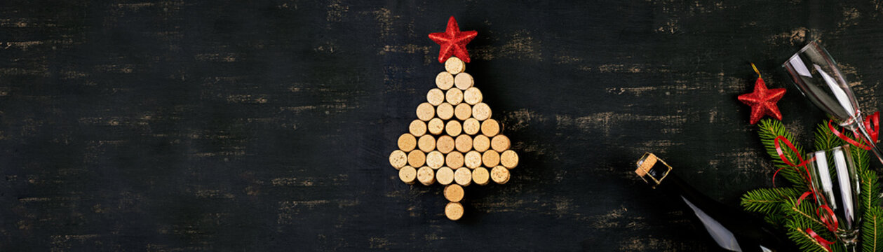 New Year decoration with christmas tree made of wine corks and bottle of champagne. Christmas background. Top view.