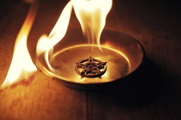 Old pentagram burning in flames