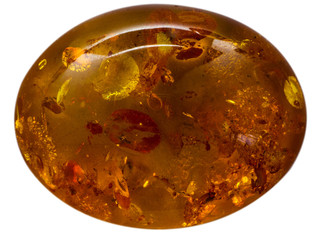 Natural cabochon of glossy manmade amber macro