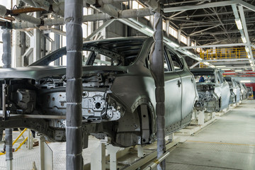 The series consists of metal bodies of cars at the automobile plant .