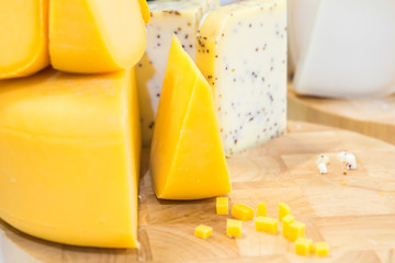 Various types of cheese on wooden desk