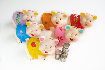 Six color piggy bank with coin pile six jar concept