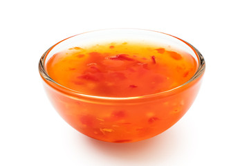 Sweet chilli sauce in a glass bowl isolated on white.