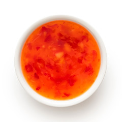 Sweet chilli sauce in a white ceramic bowl isolated on white from above.