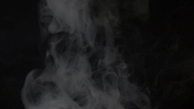 beautiful thick smoke in slow motion, on a black background