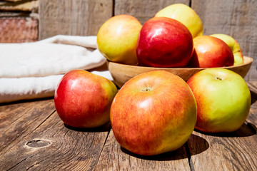 Fresh red apples with green leaves on a wooden old table. On a wooden background. Free space for text. soft focus
