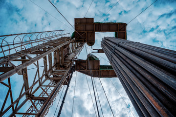 Oil and Gas Drilling Rig onshore dessert with dramatic cloudscape. Oil drilling rig operation on...