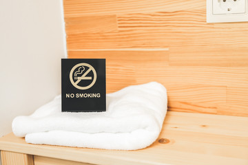 No smoking sign on the bedside table. Hotel towels.