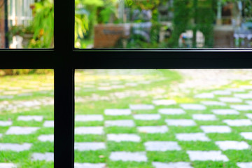Silhouette of window frame to the green fresh outdoor garden