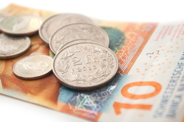 Coins and bank note of Switzerland on white background