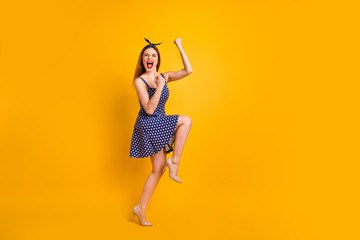 Full size photo of cute youth shout yeah have aims close eyes raise fists isolated over yellow background