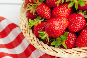 Fresh strawberry in basket on wooden background