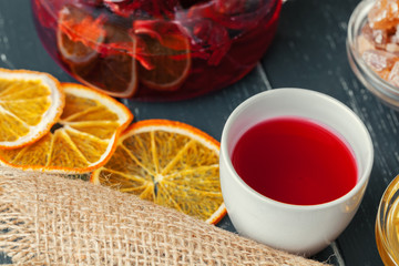 Cup of freshly brewed fruit and herbal tea, dark mood.Tea ceremony