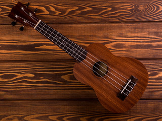 Fototapeta na wymiar Close up of ukulele on old wooden background