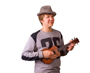 Fototapeta na wymiar Portrait of a hipster male in hat playing on ukulele. Isolated on white background.