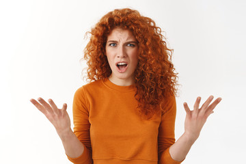 Angry outraged attractive, stylish redhead woman raising hands in dismay, complaining stare frustrated and furious, bothered bad service, shouting at manager, stand white background disappointed - obrazy, fototapety, plakaty