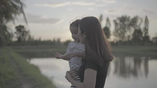 Asian moms and daughters are playing in the outdoor fun at sunset. happily, Slog3